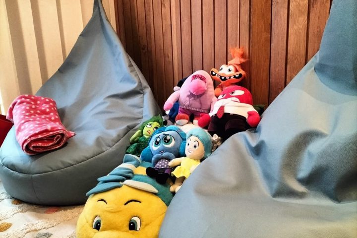 Cantinho com pufes e peluches das emoções usados nas sessões com crianças